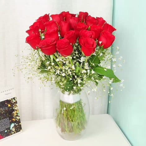 “Delight your loved ones with a stunning bouquet of 24 red roses in a glass vase, delivered on the same day.”