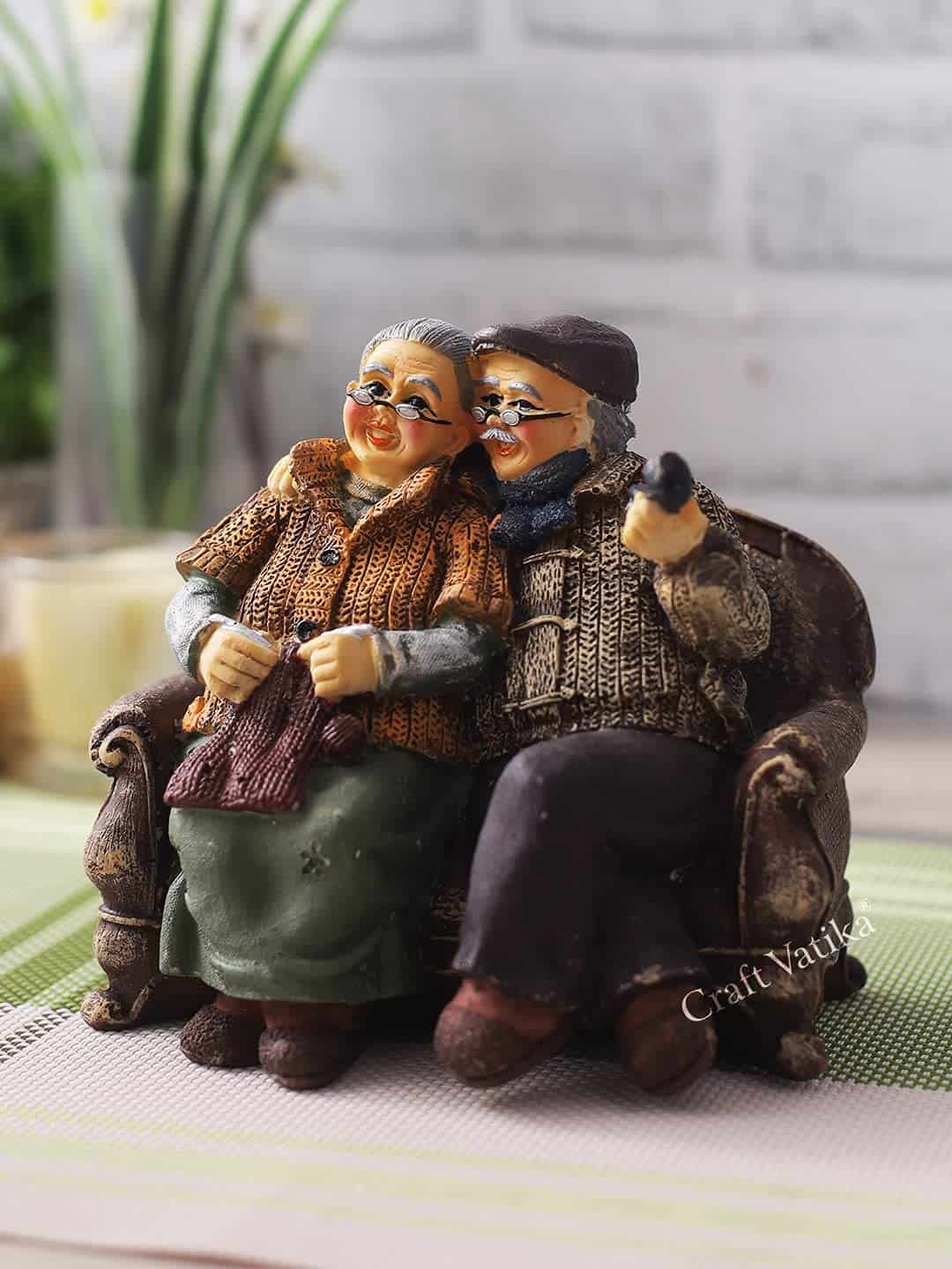 CraftVatika Dada Dadi Romantic Couple Miniatures Grand Parents on Sofa Statue Showpiece for Home Decor - Best Gift for Love, Valentine, Retirement Party, Wedding Anniversary, Multicolor